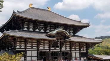 Epic Japan tour at Todai-ji Temple in Nara, showcasing traditional Japanese architecture with wooden details and curved rooftops.