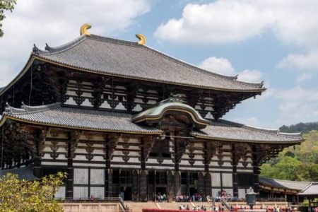 Epic Japan tour at Todai-ji Temple in Nara, showcasing traditional Japanese architecture with wooden details and curved rooftops.